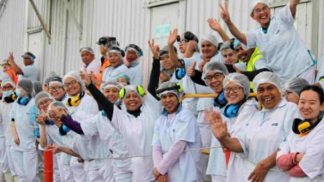 Sealord team outside a seafood processing plant 