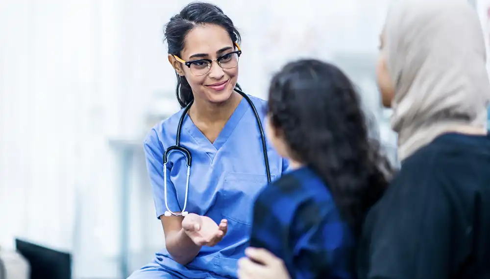 Doctor with young girl and her mother