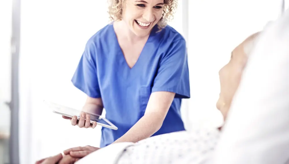 Shot of a female carer talking to her recovering male patient