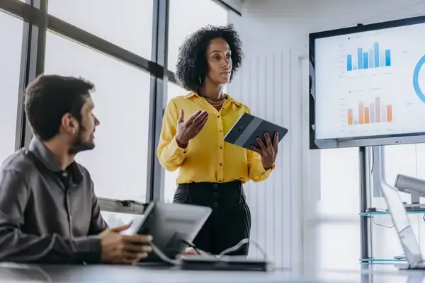 Businesswoman presenting revenue growth management systems holding digital tablet