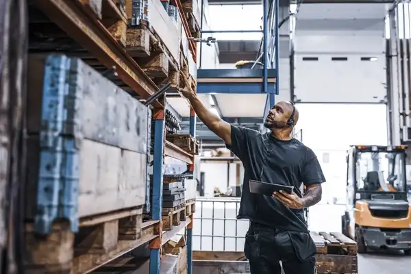 Man taking inventory in distribution warehouse