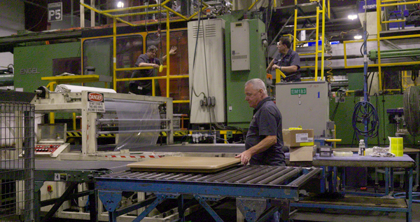 men assemble furniture in factory