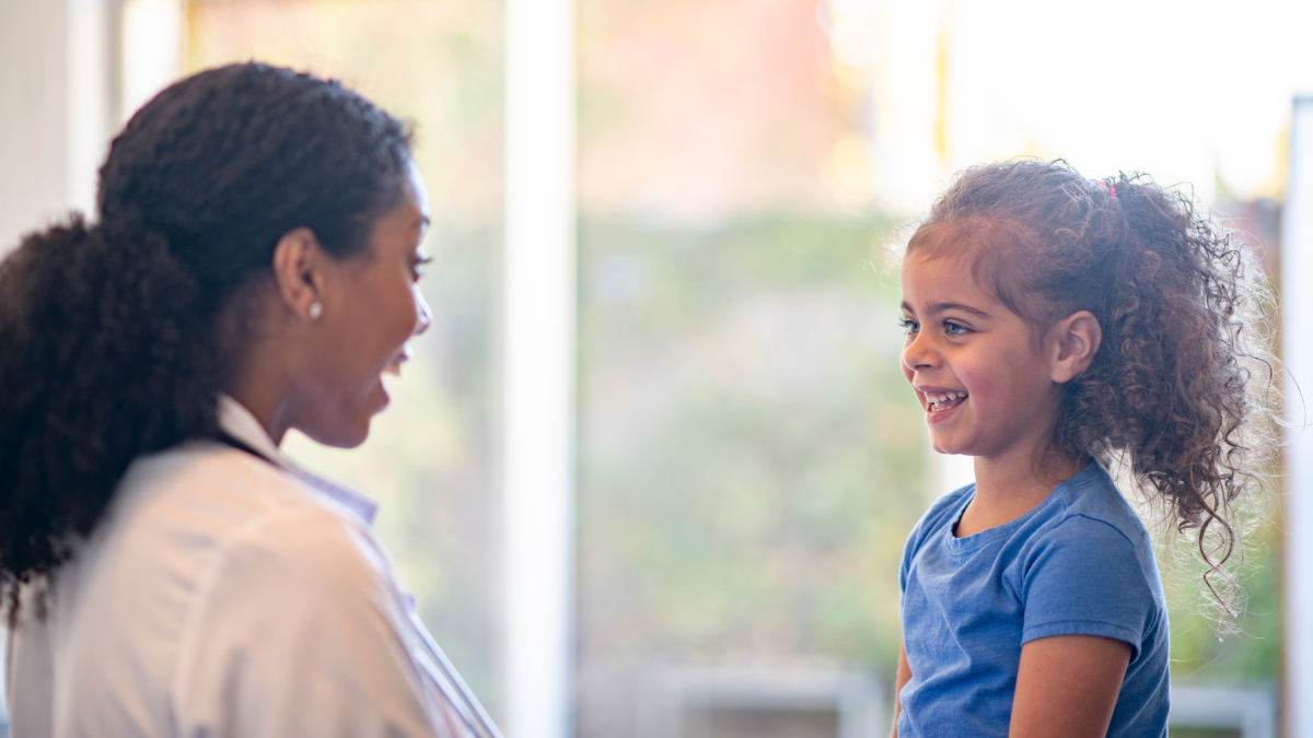 Doctor getting little girl to smile