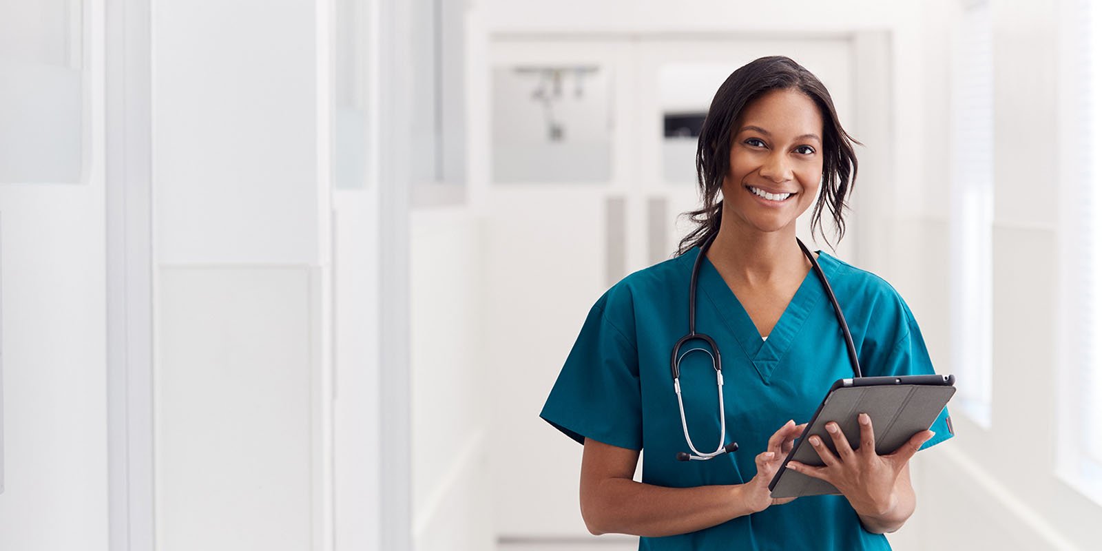 Woman nurse at work with a stethoscope and tablet