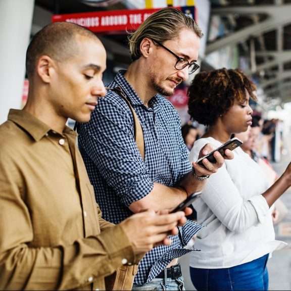 a group of people looking at devices