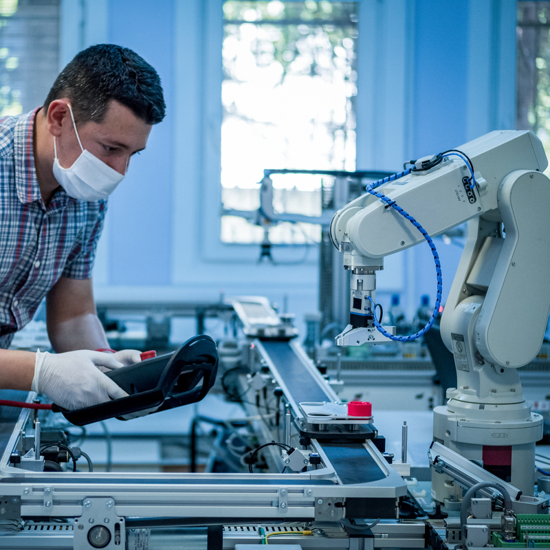 Man in manufacturing production line control with robotic automation