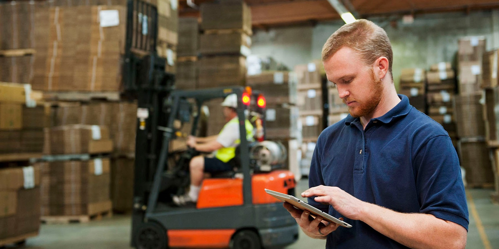 Man in a warehouse working on a tablet