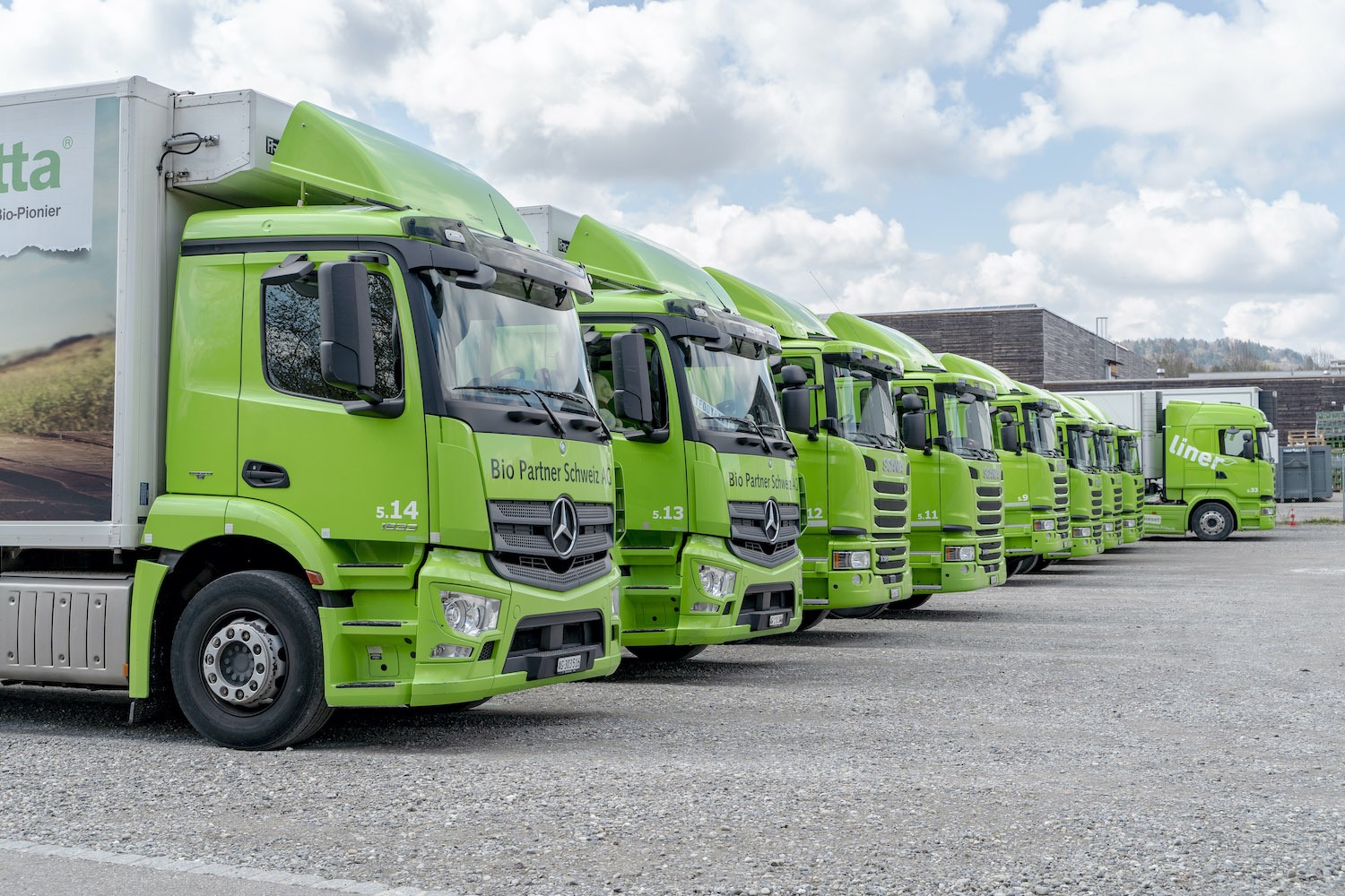 line of lime green industrial trucks