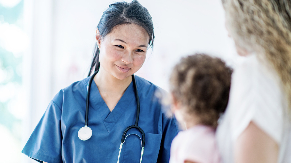 Doctor with a young patient and her mother