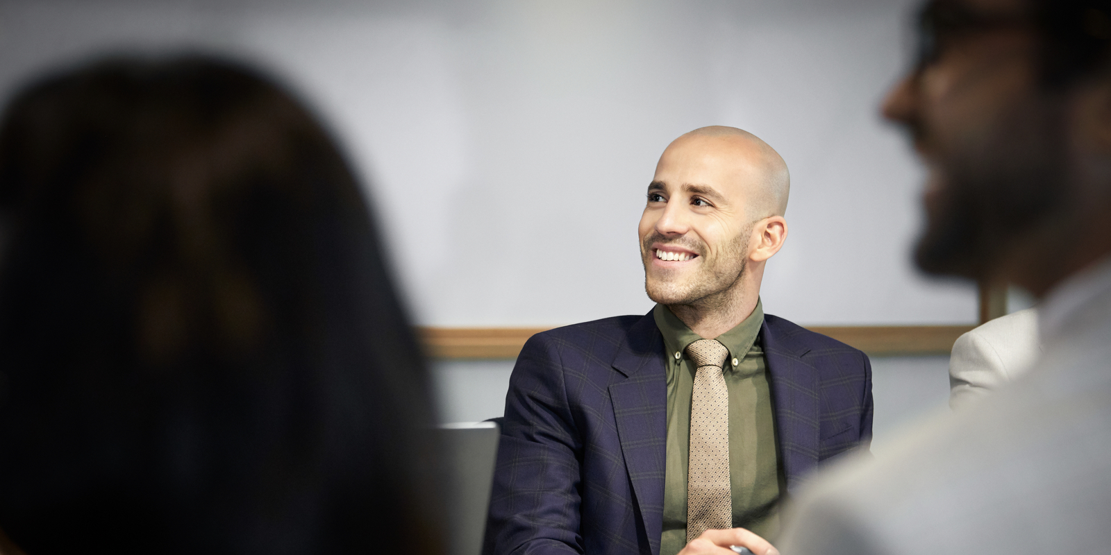 businessman looking away while listening in meeting