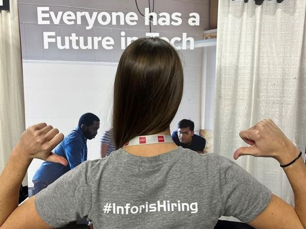 Inforian wearing #InforisHiring t-shirt at a conference