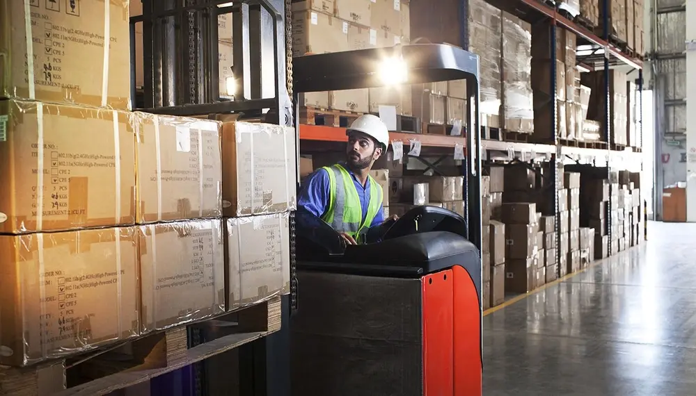 Forklift operator in a warehouse