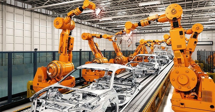 inside an automotive factory with robots building a car frame
