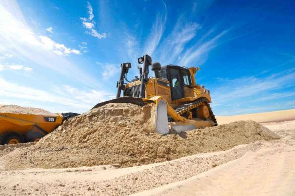 photo of a tractor scooping up dirt