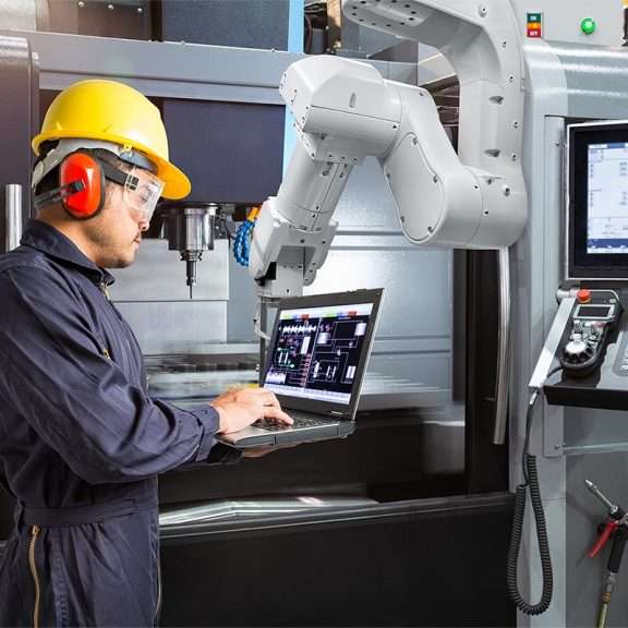 man working alongside robot