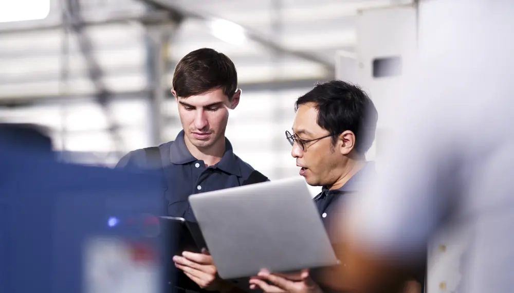 IT support technicians inspecting machine