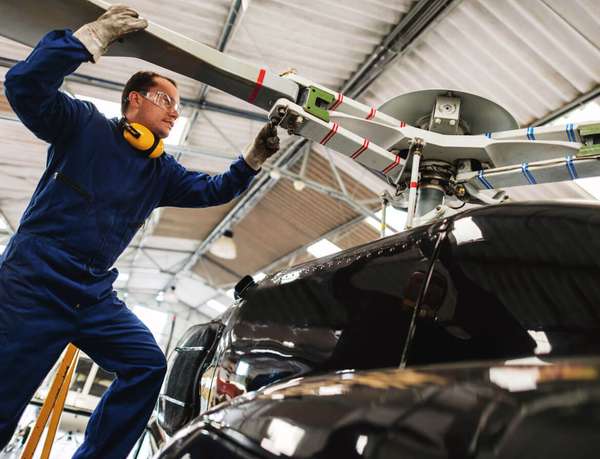 508121643_discrete-Working-Mechanic-fixing-helicopter-Dayinlife_iStock585x448