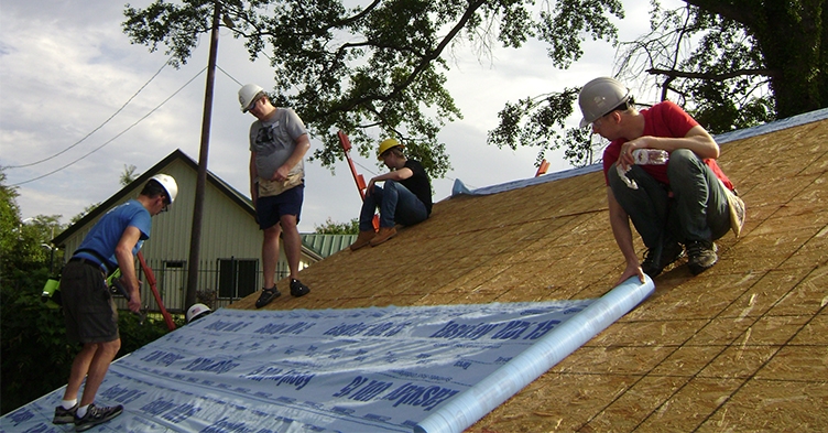 Infor volunteers on top of the roof