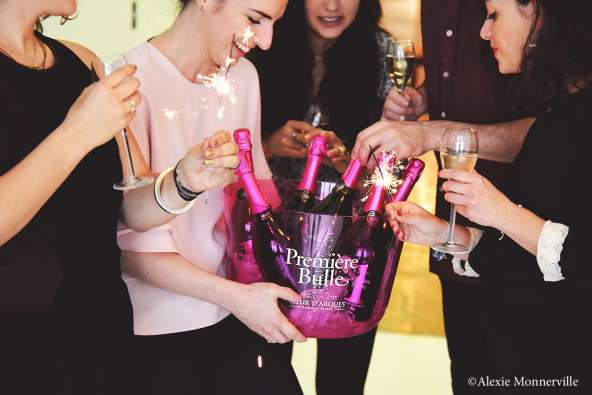 people celebrating in formalwear with a bucket of champagne