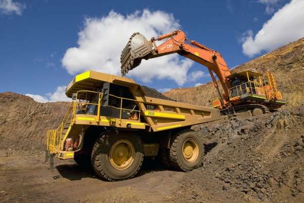 Excavator and truck in mine