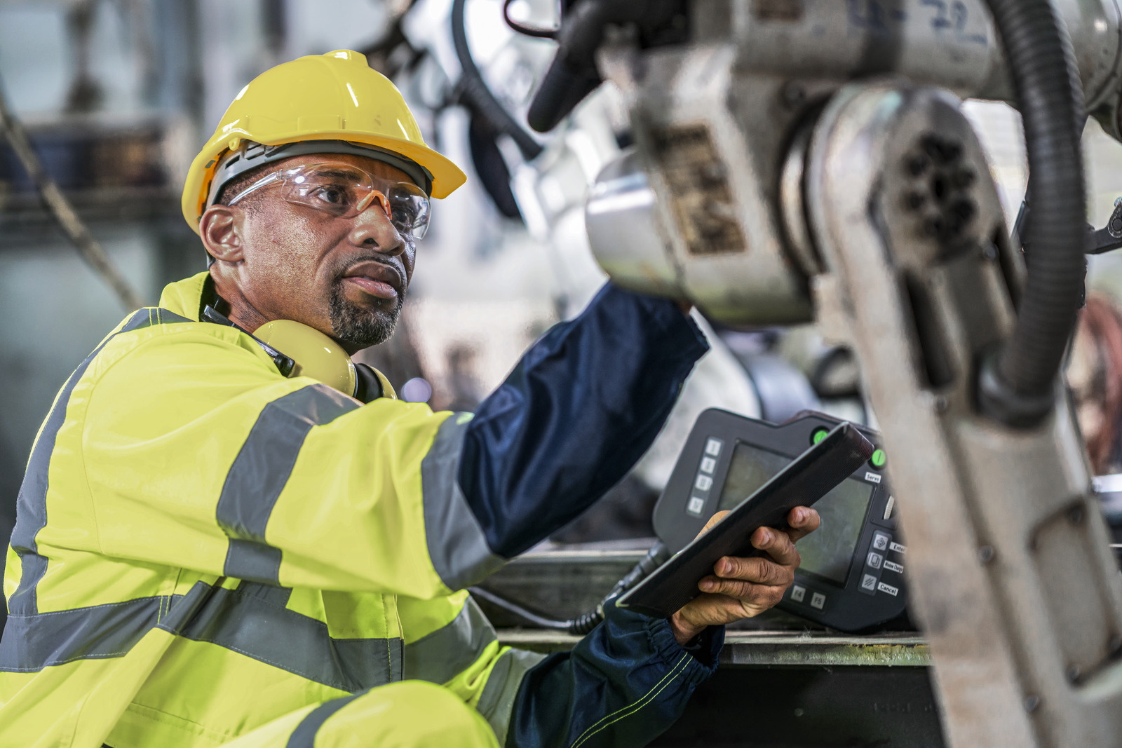 Senior inspector working in robot factory 