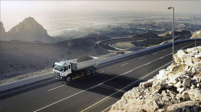 aerial photo of a dirt truck driving on a highway