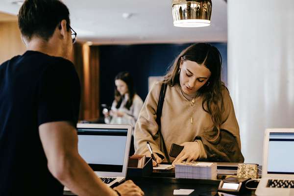 hotel receptionist helping a customer