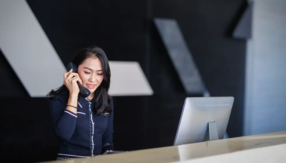 Hotel receptionist answering the phone
