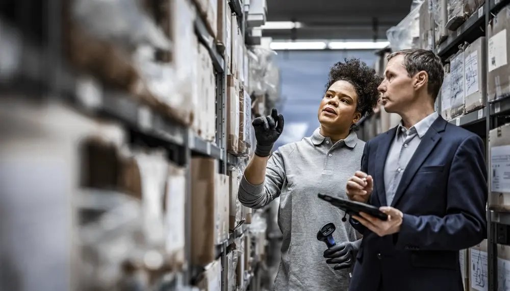  Workers taking inventory in distribution warehouse