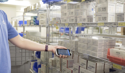 Nurse locating medical supplies in a storeroom