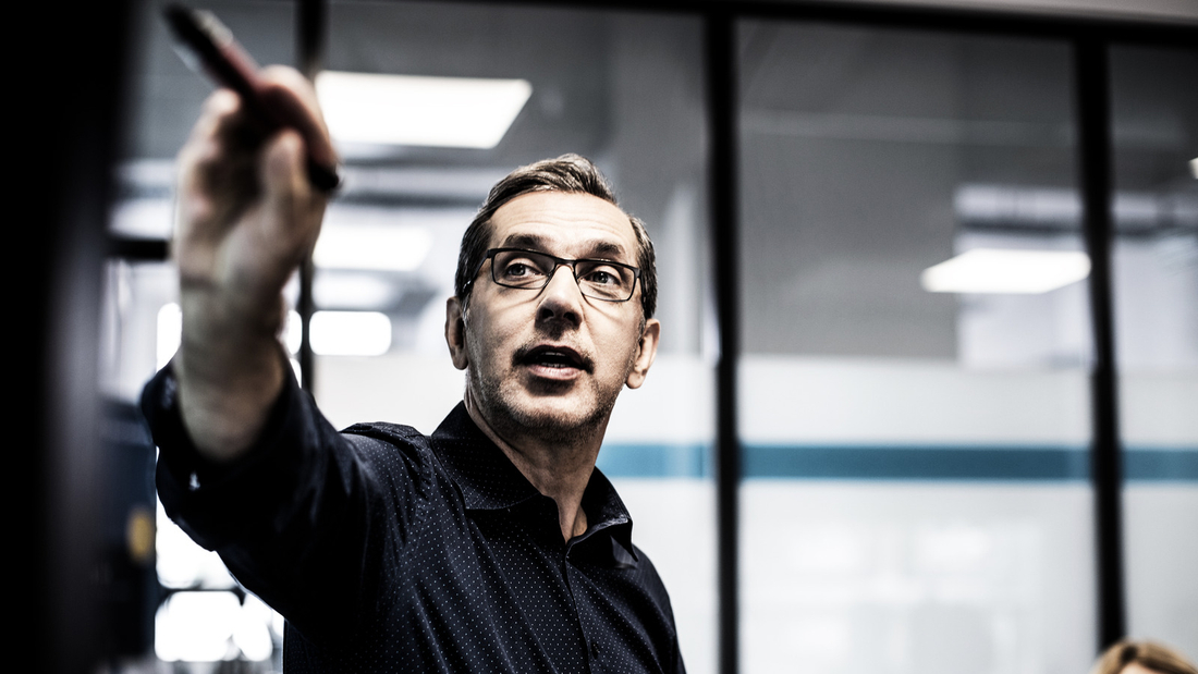 Businessman giving presentation during meeting in office