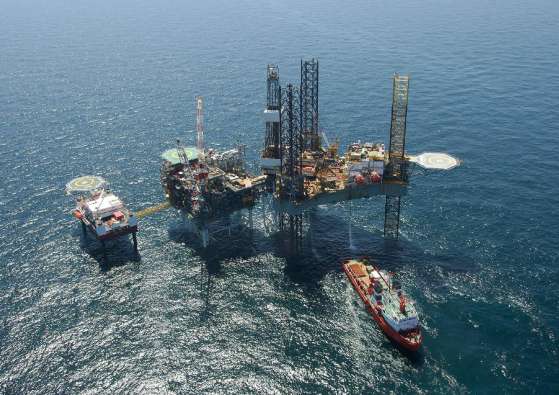 aerial photo of an oil rig in the water