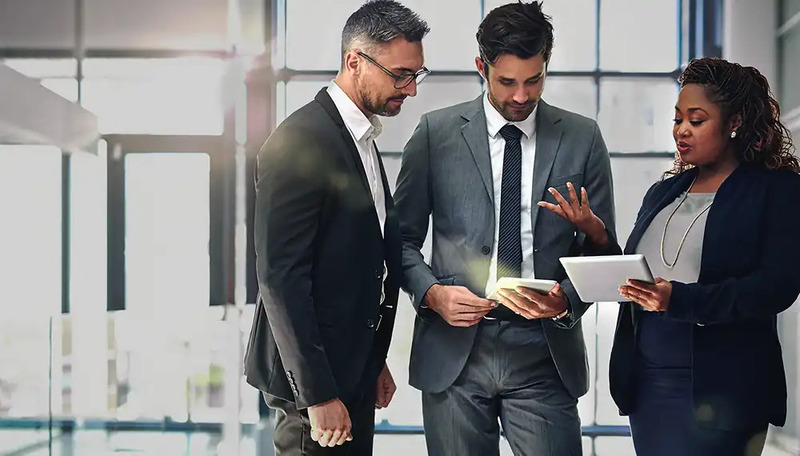 Business professionals using AI technologies on Infor and AWS