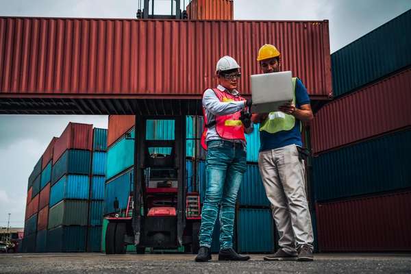 Workers in shipping container yard