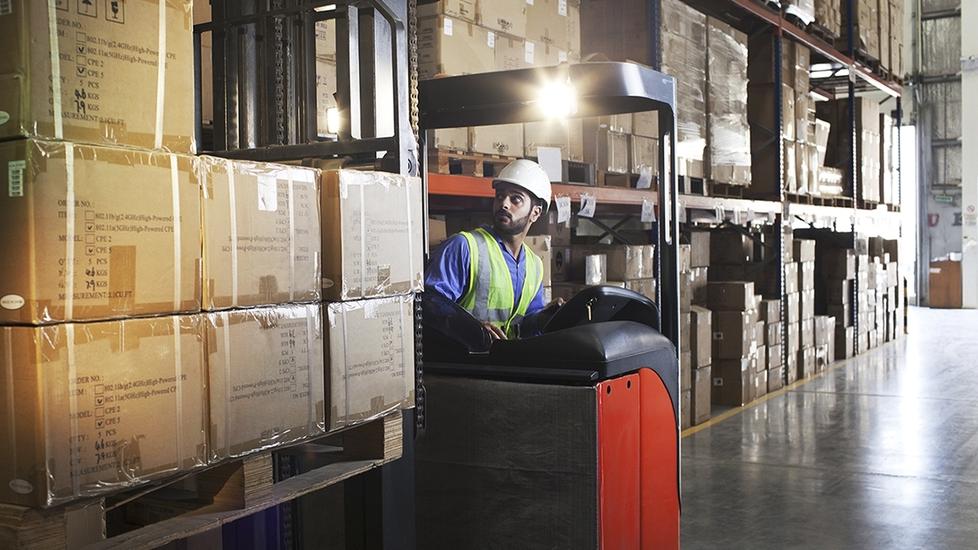 Forklift operator in a warehouse