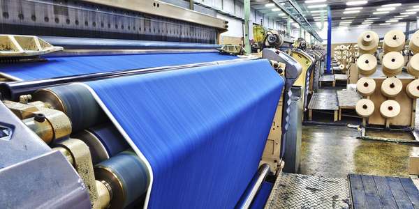 manufacturing fabric air jet looms in big   textile weaving unit  