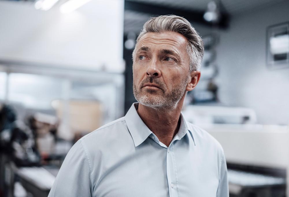 Businessman standing in a warehouse 