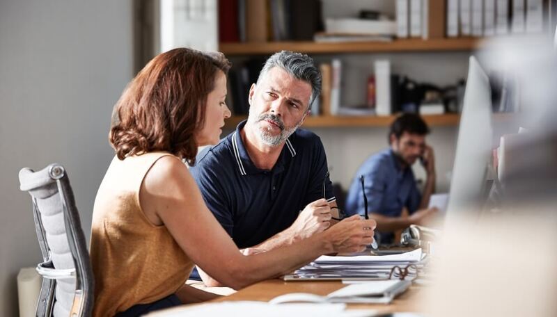 Businesspeople discussing how to modernize their IT 