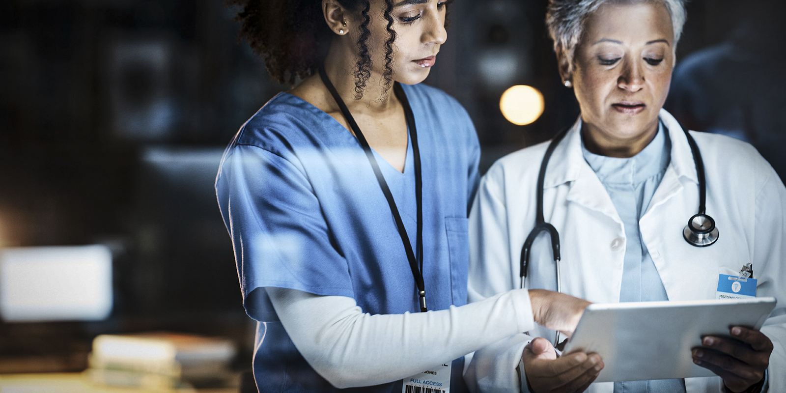 Hospital workers using AI-powered healthcare software on a tablet Confluence Health uses AI to improve patient care