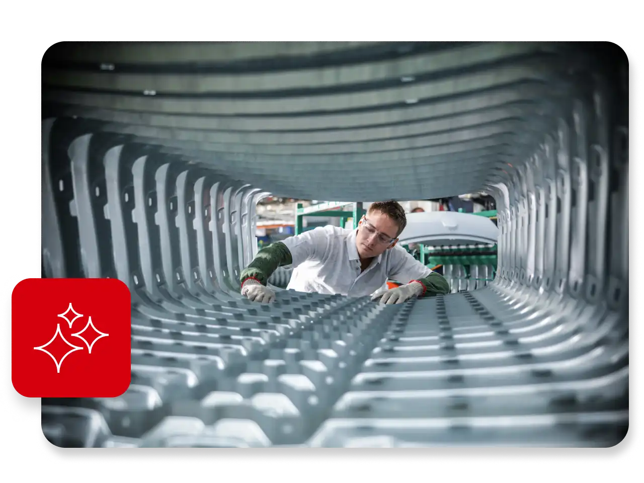 Worker inspecting car body pressing in a factory