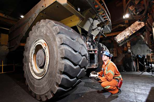 Man checking a truck tire