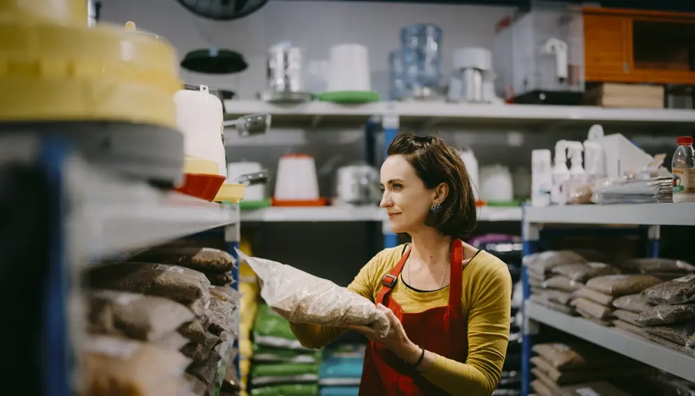 Woman working in store restocking retail display