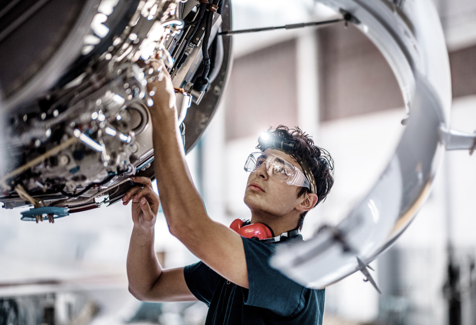 Aircraft Mechanic checking jet engine of the airplane