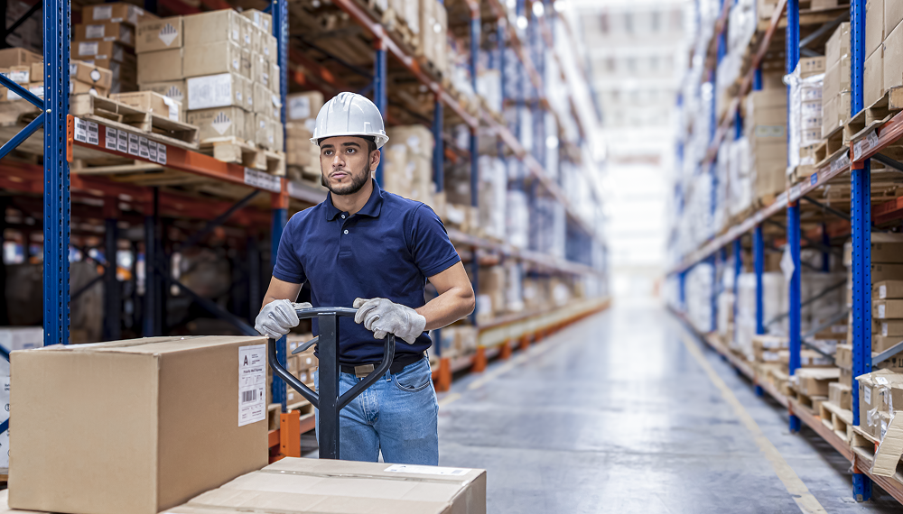 Worker moving boxes in a distribution warehouse