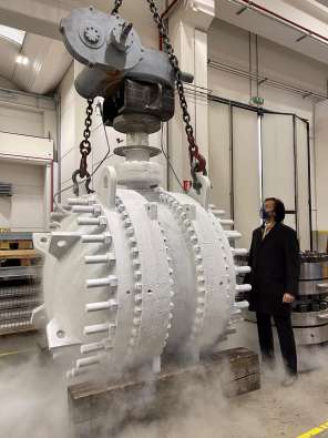 Man looking at a valve in a factory