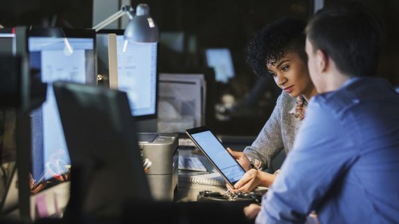 Staff using AI-powered analytics on multiple screens 