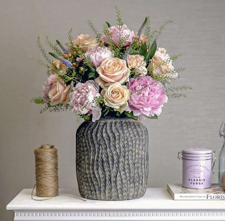 a colorful bouquet of white and pink roses in a vase