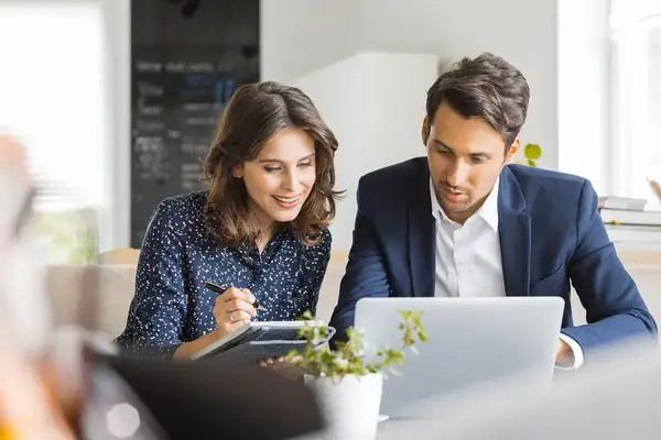Employees learning Infor ERP via our digital adoption platform on a laptop