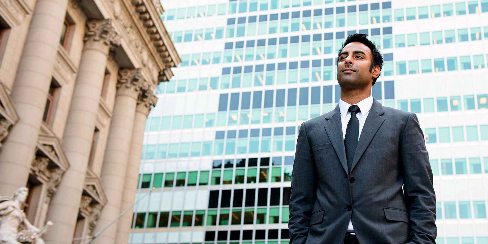 Banker standing outside a building 