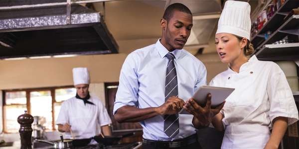 hsp hotels hsp restaurant manager chef using digital tablet kitchen